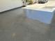 Epoxy-coated garage floor with ample room for parking and storage, in a two car garage at 6610 Barnstead Dr, Castle Pines, CO 80108