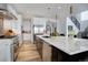 Spacious kitchen featuring stainless steel appliances, stone counters, and wood floors at 6610 Barnstead Dr, Castle Pines, CO 80108