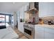 Well-appointed kitchen with stainless steel range and unique backsplash at 6610 Barnstead Dr, Castle Pines, CO 80108