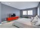 Contemporary bedroom with sleek red cabinet, modern décor, and comfortable bed bathed in natural light from bright windows at 6610 Barnstead Dr, Castle Pines, CO 80108