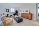 Spacious sitting room features a grand piano, comfortable seating, and ample natural light from a large window at 6610 Barnstead Dr, Castle Pines, CO 80108