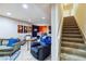 Basement featuring stairs, TV, seating, and a bar area at 15501 E 112Th Ave # 20C, Commerce City, CO 80022