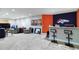 Finished basement rec room with Broncos logo, bar, and living area at 15501 E 112Th Ave # 20C, Commerce City, CO 80022