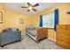 Cozy bedroom with bright yellow walls, blue accents, natural light, and furniture at 3308 W 11Th Avenue Pl, Broomfield, CO 80020