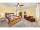 Comfortable bedroom with a bed, cushioned chair and side tables at 3308 W 11Th Avenue Pl, Broomfield, CO 80020