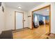 Welcoming foyer with hardwood floors, coat hooks, and an open view into the living room at 3308 W 11Th Avenue Pl, Broomfield, CO 80020