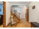 Hallway featuring hardwood floors, a staircase, and a view of multiple rooms, showcasing the home's layout at 3308 W 11Th Avenue Pl, Broomfield, CO 80020