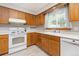 Well-lit kitchen showcases light wood cabinets and modern white appliances at 3308 W 11Th Avenue Pl, Broomfield, CO 80020