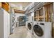 Unfinished basement laundry room with modern washer and dryer and storage shelving at 3308 W 11Th Avenue Pl, Broomfield, CO 80020