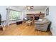 Inviting living room with a brick fireplace, large window and hardwood floors at 3308 W 11Th Avenue Pl, Broomfield, CO 80020