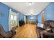 Bright living room with hardwood floors, a large window, and comfortable seating, perfect for relaxing or entertaining at 3308 W 11Th Avenue Pl, Broomfield, CO 80020