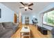 Spacious living room with light blue walls, wood floors, and a ceiling fan at 3308 W 11Th Avenue Pl, Broomfield, CO 80020