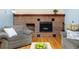Cozy living room with brick fireplace and mantle at 3308 W 11Th Avenue Pl, Broomfield, CO 80020