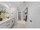 Elegant bathroom featuring double sinks, sleek fixtures, and a view toward shower and closet at 17164 W 91St Ln, Arvada, CO 80007