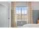 Bedroom with large window, hardwood floors, neutral walls, and scenic outdoor views at 17164 W 91St Ln, Arvada, CO 80007