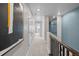Bright hallway with modern art, neutral walls, carpet, and a view through to the window at the end at 17164 W 91St Ln, Arvada, CO 80007