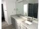 Bathroom featuring double sinks, granite counters, and a tiled shower at 11282 Osage N Cir # F, Northglenn, CO 80234