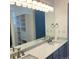 Bright bathroom featuring double sinks, granite countertops, and a storage tower at 11282 Osage N Cir # F, Northglenn, CO 80234