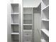 Custom white closet with shelves, drawers, and hanging rods maximizes storage space at 11282 Osage N Cir # F, Northglenn, CO 80234