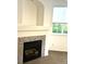 Cozy room features a fireplace with decorative tile surround and a bright window at 11282 Osage N Cir # F, Northglenn, CO 80234