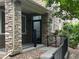 Stylish front porch with stone accents and a black metal railing at 11282 Osage N Cir # F, Northglenn, CO 80234
