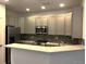 Modern kitchen featuring gray cabinets, stainless steel appliances, and a tiled backsplash at 11282 Osage N Cir # F, Northglenn, CO 80234