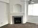 Cozy living room featuring a fireplace with decorative tile and a ceiling fan at 11282 Osage N Cir # F, Northglenn, CO 80234