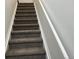 Carpeted staircase with white railing at 11282 Osage N Cir # F, Northglenn, CO 80234