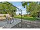 Charming backyard retreat featuring a cozy seating area, mature trees, and a well-maintained lawn at 9325 Utica St, Westminster, CO 80031