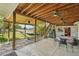 Backyard features a covered patio with ceiling fans, a dining table, hammock, built-in grill, and stairs to yard at 9325 Utica St, Westminster, CO 80031
