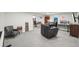 Finished basement office space features gray carpet, a built in bookshelf, a desk and a comfortable leather chair at 9325 Utica St, Westminster, CO 80031