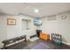 Finished basement workout area features a TV, workout bench, free weights, rubber flooring, and neutral paint at 9325 Utica St, Westminster, CO 80031