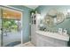 Bright bathroom with a walkout to a deck, stylish vanity, and elegant fixtures at 9325 Utica St, Westminster, CO 80031