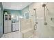 Modern bathroom with large glass shower, tiled bench, and updated vanity at 9325 Utica St, Westminster, CO 80031