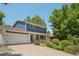 Charming home with a well-manicured lawn, mature trees, and a welcoming two-car garage at 9325 Utica St, Westminster, CO 80031