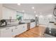 Modern kitchen with sleek white cabinetry, stainless steel appliances, and gray countertops at 9325 Utica St, Westminster, CO 80031
