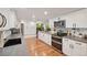 Modern kitchen boasts stainless steel appliances, lots of cabinet space, and stone countertops at 9325 Utica St, Westminster, CO 80031