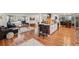 Bright and airy open floorplan featuring the living room and kitchen, with hardwood floors throughout at 9325 Utica St, Westminster, CO 80031