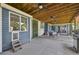 Inviting covered patio features ceiling fans, a dining area, and access to the home's interior via sliding glass doors at 9325 Utica St, Westminster, CO 80031