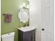 Charming powder room features stylish vanity, ornate mirror, and fresh green wall at 9325 Utica St, Westminster, CO 80031