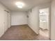 Spacious bedroom with neutral carpeting and access to a full bathroom at 1825 Kendall St # 215, Lakewood, CO 80214