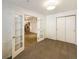 Bedroom with double doors opening to living area and carpet at 1825 Kendall St # 215, Lakewood, CO 80214
