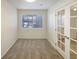 Bright bedroom featuring window and double doors at 1825 Kendall St # 215, Lakewood, CO 80214