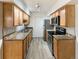 Well-equipped kitchen with stainless steel appliances and wood cabinets at 1825 Kendall St # 215, Lakewood, CO 80214