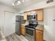 Kitchen features stainless steel appliances and light wood cabinets at 1825 Kendall St # 215, Lakewood, CO 80214