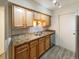 Kitchen with double sink, light wood cabinets, and tile backsplash at 1825 Kendall St # 215, Lakewood, CO 80214