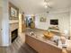 Virtually staged living room with fireplace and open concept kitchen at 1825 Kendall St # 215, Lakewood, CO 80214