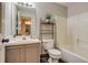 Well-lit bathroom with a shower-tub combo, a single sink vanity, and tiled flooring at 999 Osceola St, Denver, CO 80204