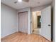 Bedroom with wood floor features ceiling fan, closet, and a door leading to a hallway at 999 Osceola St, Denver, CO 80204