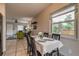 Bright dining area featuring a window, and tile floors, complemented by open access to the living room at 999 Osceola St, Denver, CO 80204